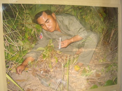 Picture of Aki Ra disarming a landmine in Cambodia