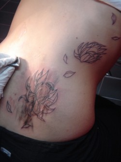 My friend's tattoo on her back flowers, no colors yet