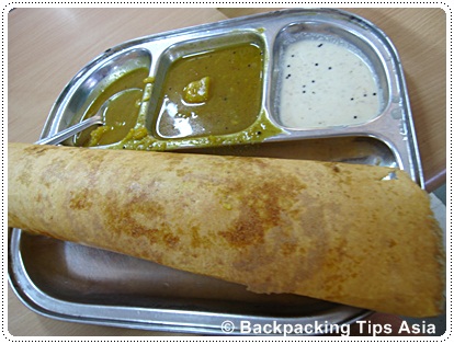 Eating out in delhi at a restaurant in Delhi, here eating masala dosa