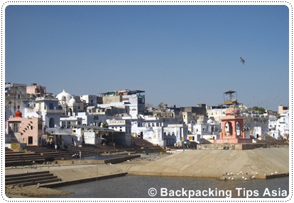 Premium Photo | Framed view from archway at pushkar, rajasthan, india. temples, buildings and ghats on the holy water of the lake at sunset.